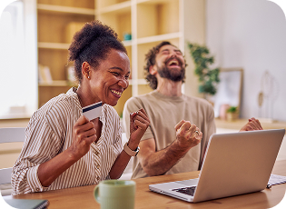 Couple in joy while one holds a Mastercard
